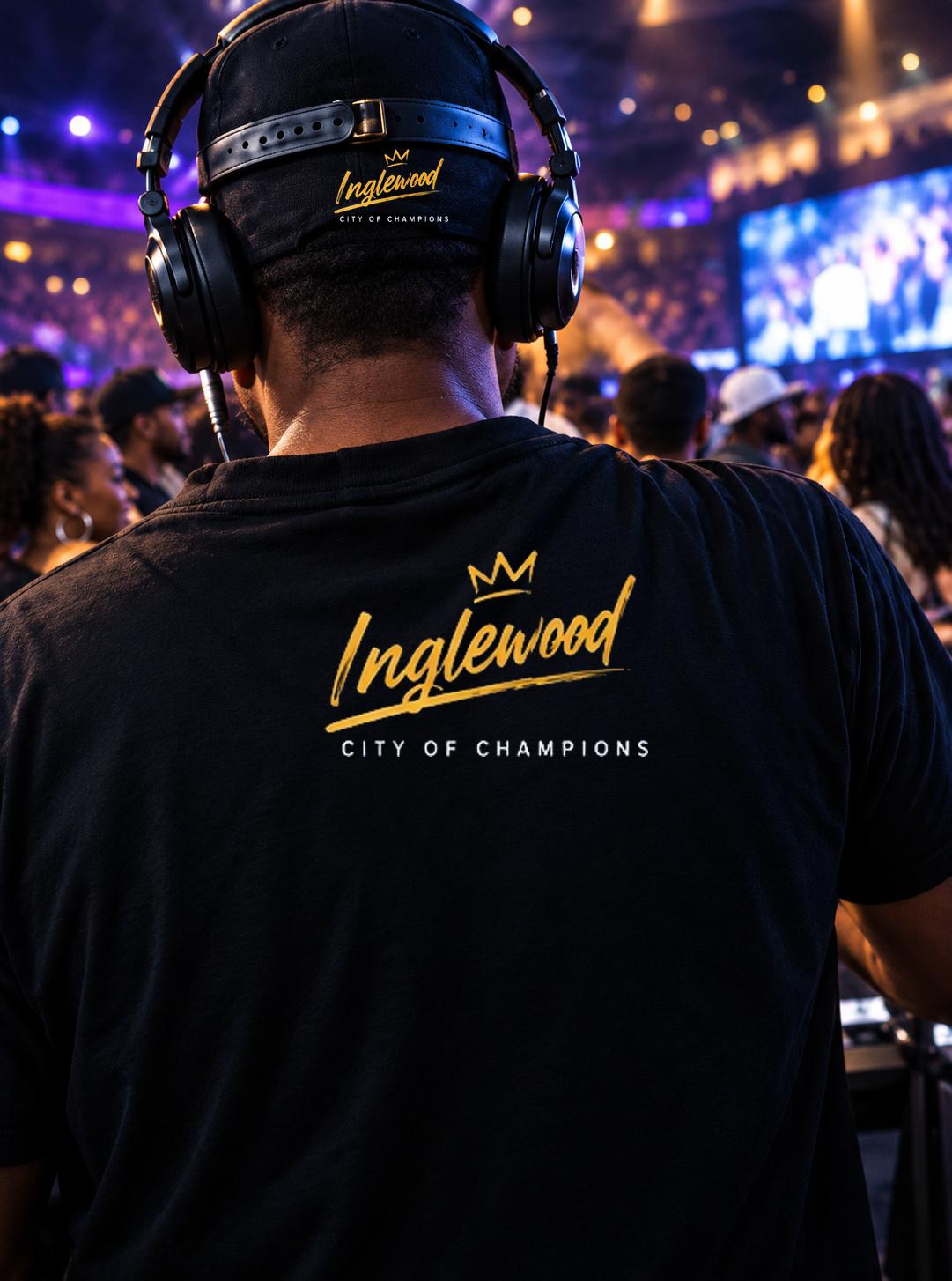 A DJ in headphones and an Inglewood crown shirt facing the crowd